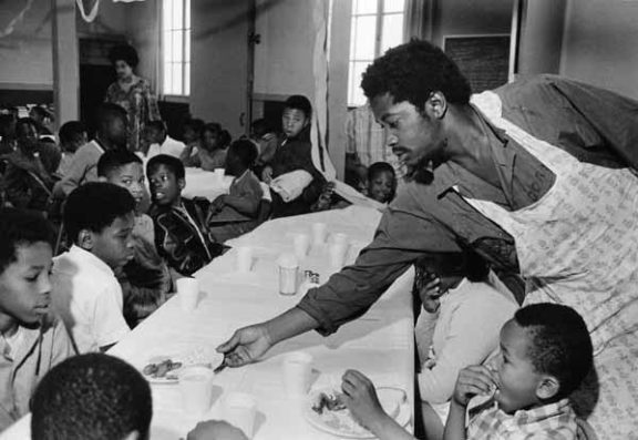 Black-Panthers-Charles-Bursey-serving-breakfast-by-Pirkle-Jones