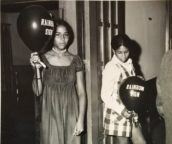 Girls Holding Rainbow Sign balloons